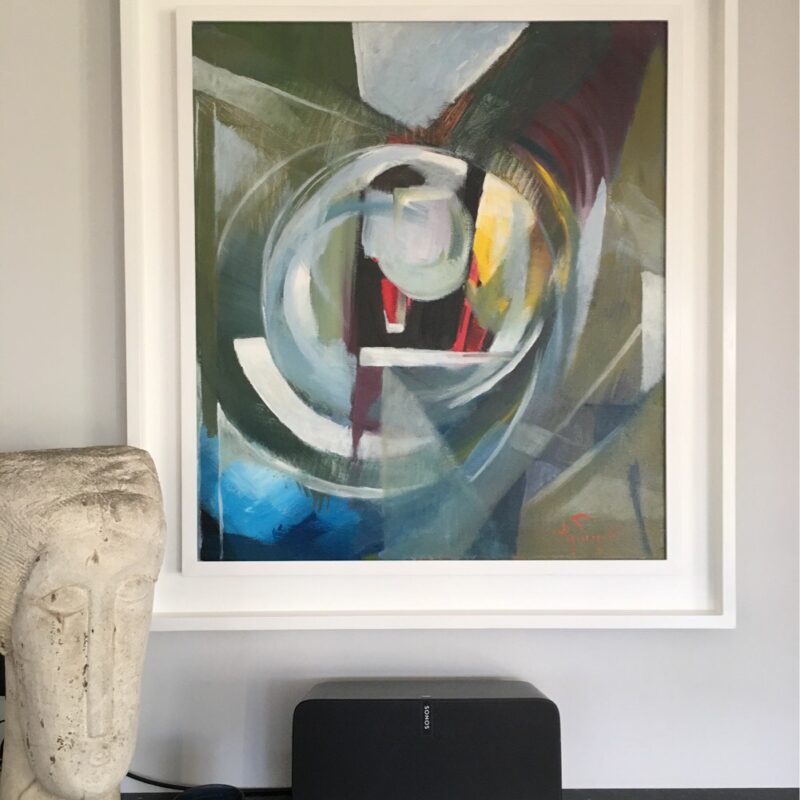 An abstract painting in a white frame