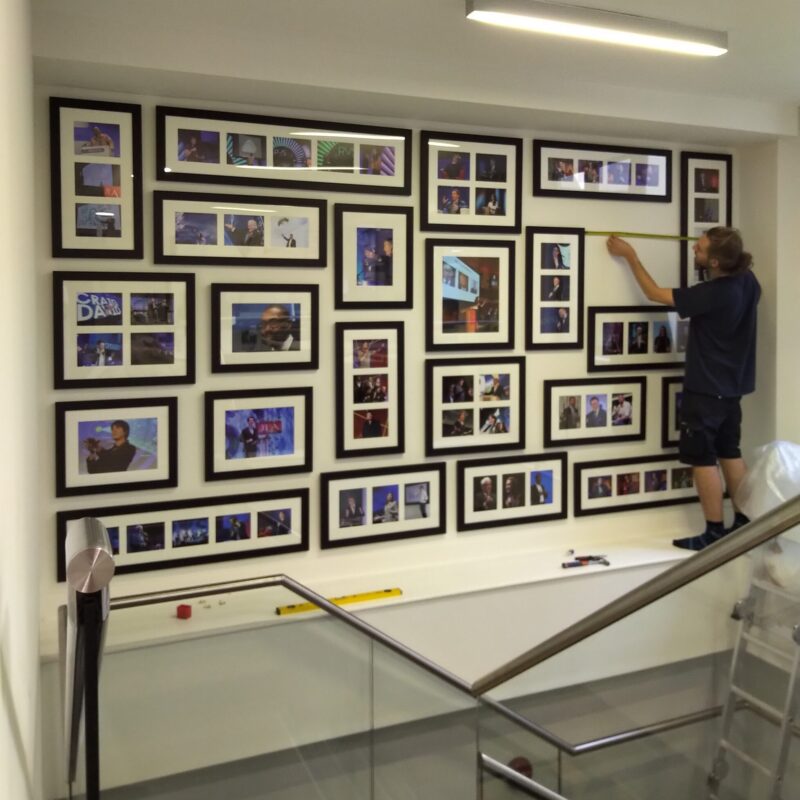 Hanging frames over a staircase