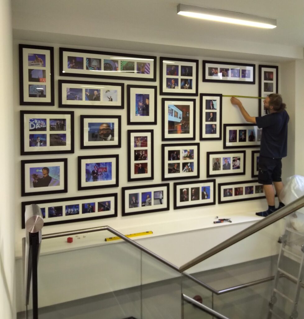 Hanging frames over a staircase