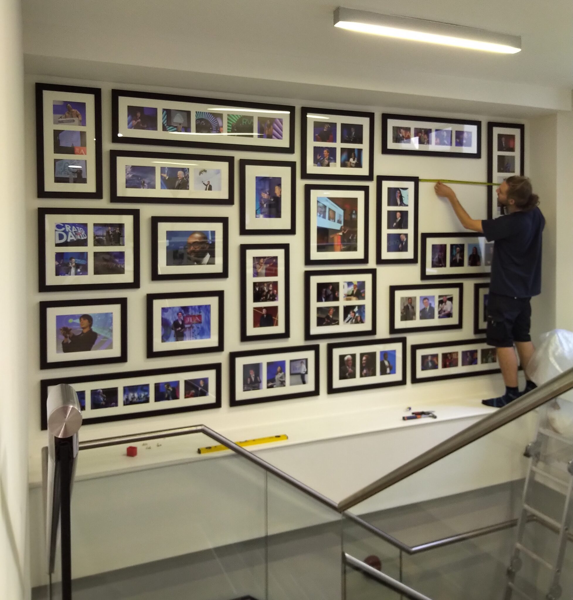 Hanging frames over a staircase