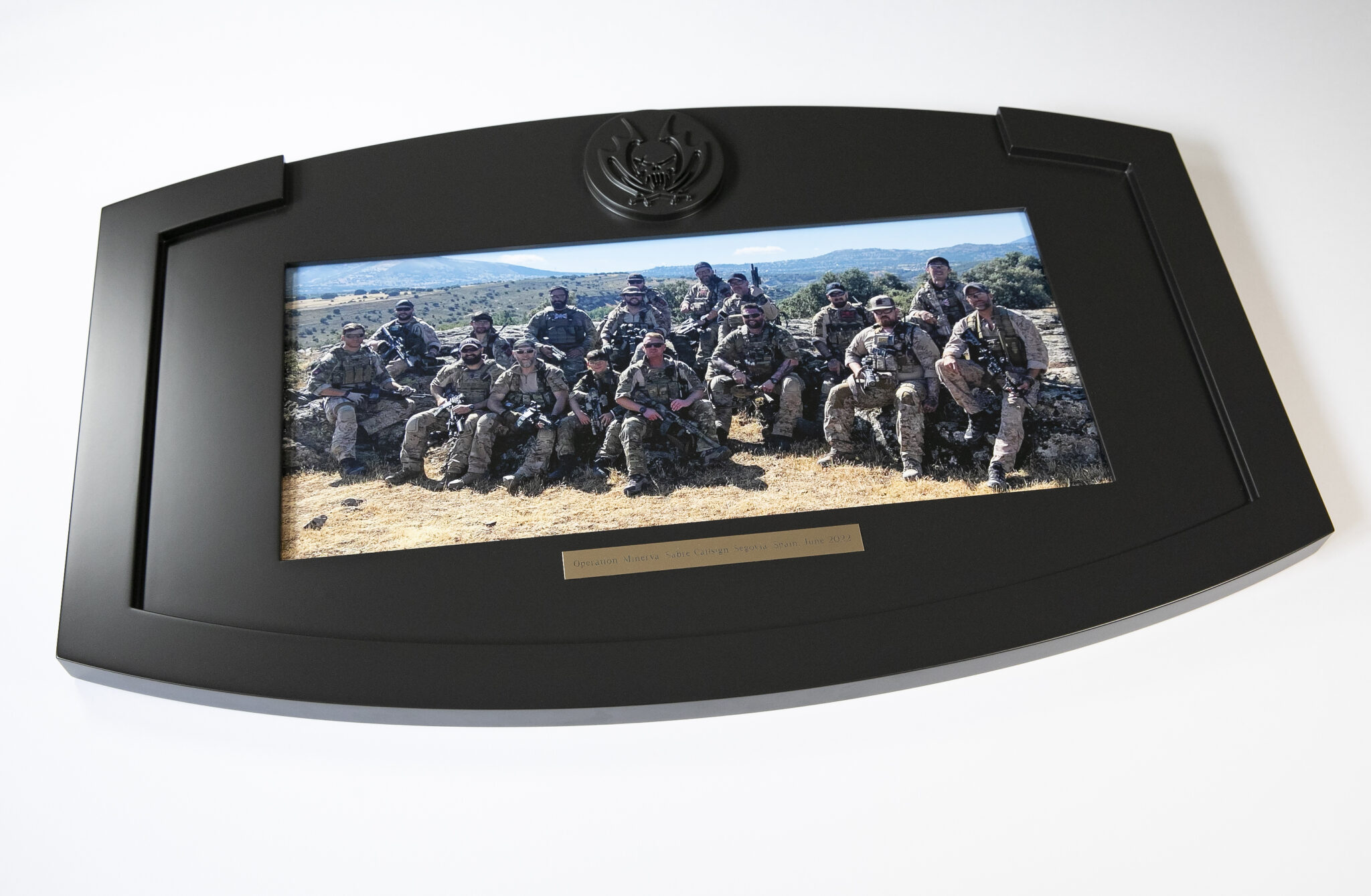 A framed group photo of military personnel in uniform, set against a picturesque landscape, captures a moment of unity and strength. The scene is beautifully preserved as an art print, showcasing the discipline and camaraderie of the armed forces.