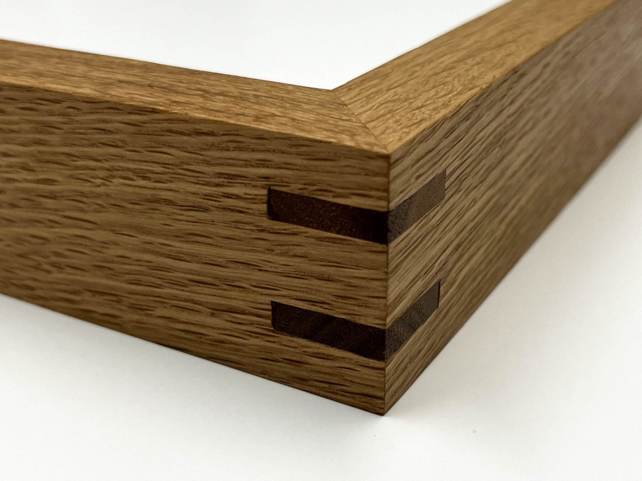 Close-up of frame joints showing precise joinery with two visible dark wood splines.