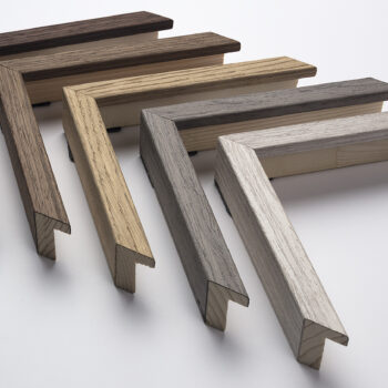 Seven L-shaped wood samples in various shades arranged in a fan pattern on a white surface.