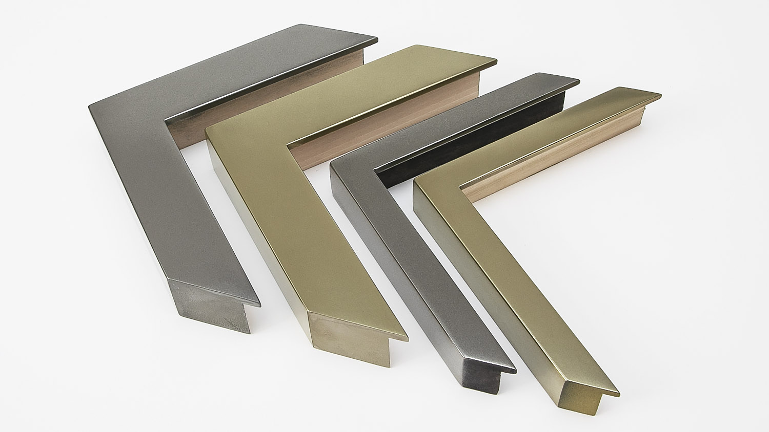 Four metallic L-shaped picture frame corners in different sizes and finishes on a white background.