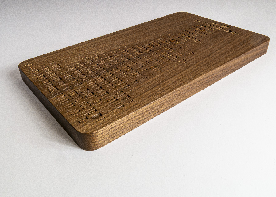 A wooden chopping board with "DNA" carvings shown on a white background.
