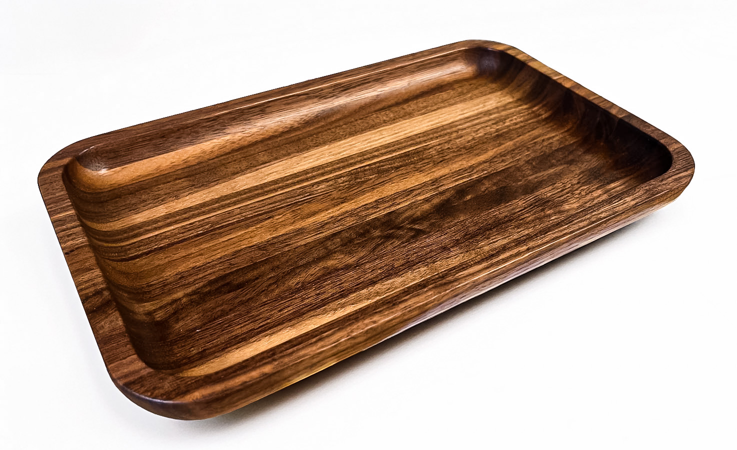 Rectangular walnut wood tray with rounded corners and a smooth, polished surface on a white background.