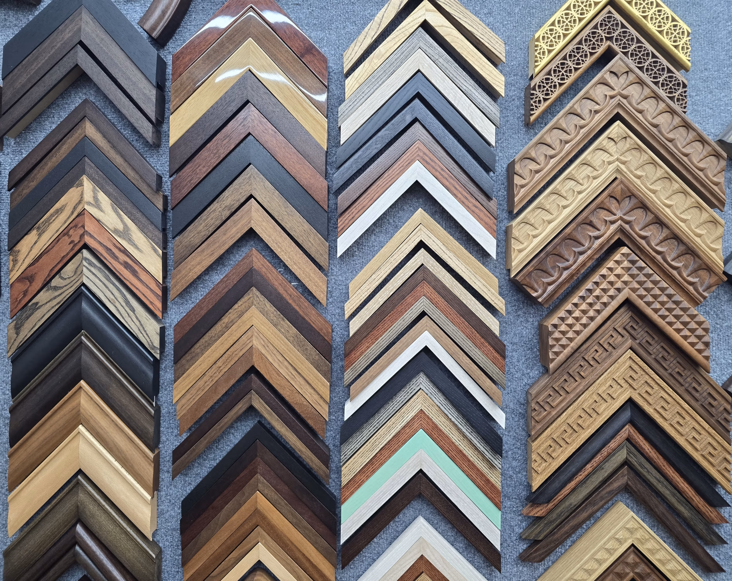 A wall of picture frame corners or different colour woods and carved designs