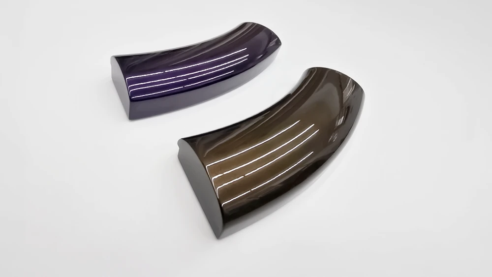 two curved picture frame sections. One gloss purple, one gloss brown on a white background
