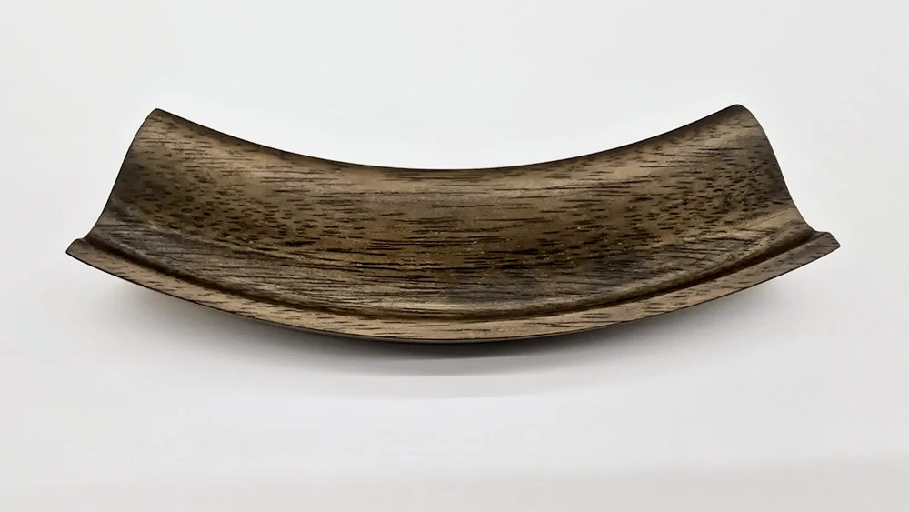 soft brown curved section of a picture frame moulding