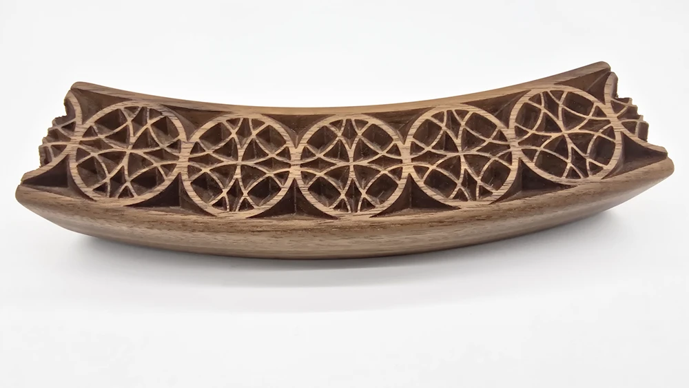 curved walnut picture frame section with an geometric Islamic art inspired carved face