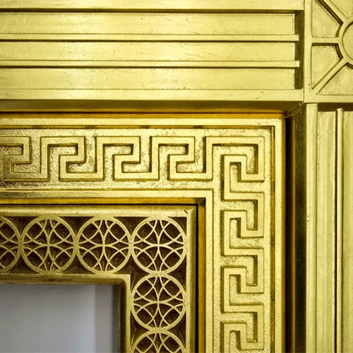 Three different ornate gilded picture frame corners next to one another