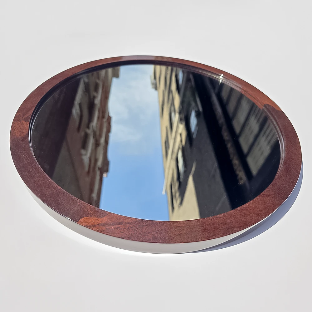 A walnut mirror frame with mahogany stain and mirror gloss lacquer