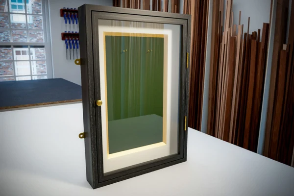 A SohoFrames computr render of the proposed design of a shadow box display cabinet frame in black walnut with a green velvet panel